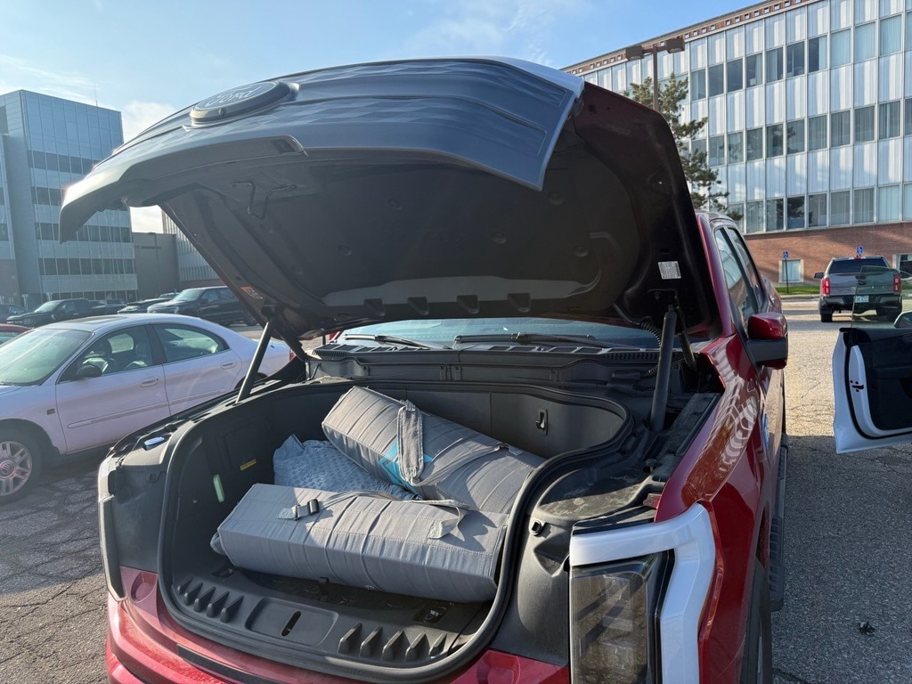 Dapo Adewusi, vehicle engineering manager for both the Mustang Mach-E and the F-150 Lightning, uses the Mega Power Frunk to help with his children's activities.